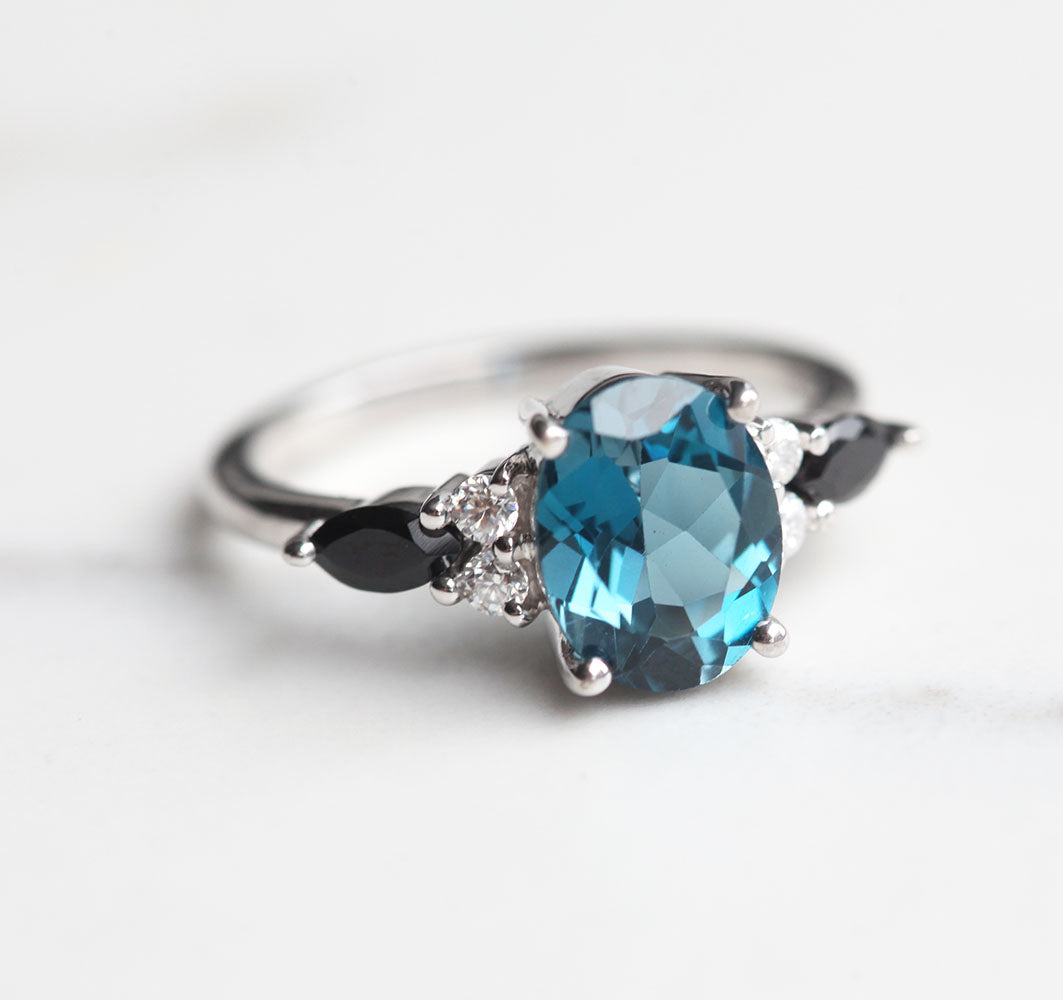 Lauryn Oval London Blue Topaz Ring with Moissanites and Black Spinel